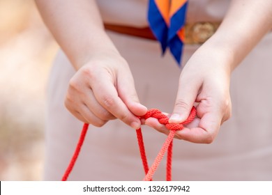 Scout Knot Learning In Forest In Camping Of Boy Scout On Hills, Teacher Holding Rope To Show Example Scout Knot To Student In Thailand, Teacher Wearing Scout Uniform.