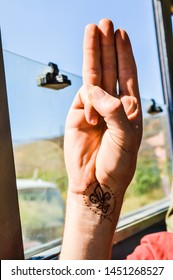 Scout Salute With Scouting Emblem Fleur De Lis On The Rist, Inside A Bus On A Hike