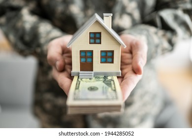 SCRA Program. Military Army Man In Uniform Holding New House - Powered by Shutterstock