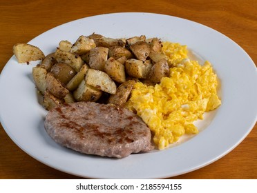 Scramble Eggs Served With Home Fries And Sausage Patty