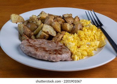 Scramble Eggs Served With Home Fries And Sausage Patty