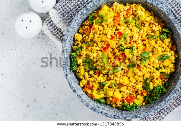 Scramble tofu with vegetables in a pan. Vegan\
Alternative Omelet.