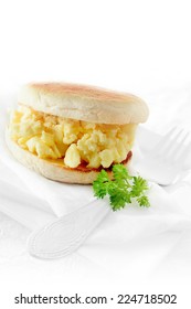 Scrambled Egg Breakfast Muffin Against A White Background. Copy Space.