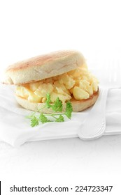 Scrambled Egg Breakfast Muffin Against A White Background. Copy Space.