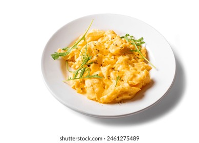 Scrambled eggs with arugula on white plate isolated on white background. Healthy breakfast - fluffy scrambled eggs, design element.