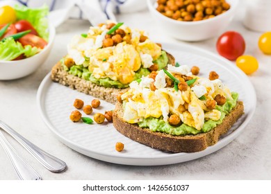 Scrambled eggs avocado feta chickpeas breakfast sandwiches. Selective focus, space for text. - Powered by Shutterstock