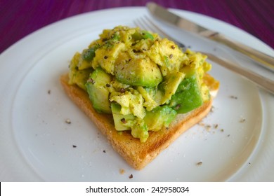 Scrambled Eggs With Avocado On Toasted Bread