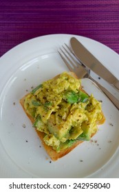 Scrambled Eggs With Avocado On Toasted Bread