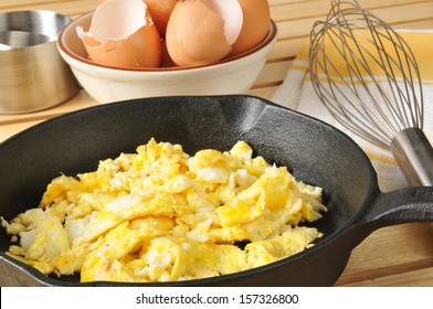 Scrambled Eggs With Brown Egg Shells In A Bowl Behind