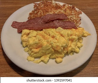 Scrambled Eggs With Cheddar Cheese, Turkey Bacon And Hash Brown Potatoes.