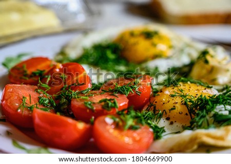Scrambled eggs with cherry tomatoes for breakfast. Selective focus.