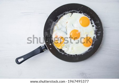 Scrambled eggs in frying pan. National Ukrainian or belorussian food. Breakfast, lunch. Top view, selective focus, rustic style