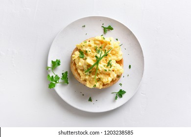 Scrambled Eggs, Omelette On Bun. Healthy Snack For Breakfast On White Stone Background. Top View