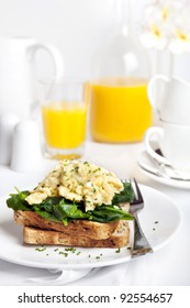 Scrambled Eggs On Toast, With Wilted Spinach.