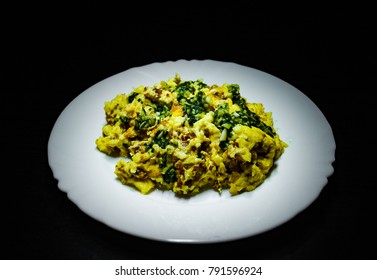 Scrambled Eggs With Pesto Sauce On White Plate On Dark Wooden Background