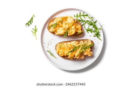 Scrambled Eggs Sandwiches on white plate isolated on white background, healthy keto breakfast. Whole grain toasts with scramble eggs and organic arugula microgreens, design element. - Powered by Shutterstock