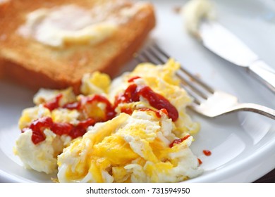 Scrambled Eggs With Sriracha Hot Chili Sauce And Buttered Toast