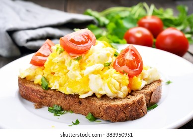 Scrambled Eggs With Tomato On Bread, Close Up View.