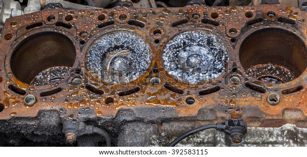 Scrap Auto Car\
parts.  Old rusting engine\
block.