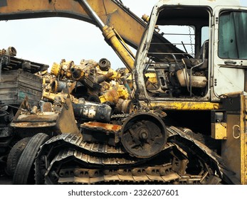 Scrap bulldozer and machinery part at junkyard. Construction equipment in unusable condition and metal materials for spare part or recycling.   - Powered by Shutterstock