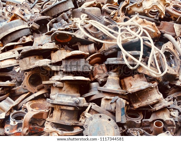 Scrap Car and machinery Parts. Scrap parts in\
garage wall. Scrap parts removed from used cars and machinery.\
Parts isolated from the unused car and machinery. Scraps for second\
used part shop.