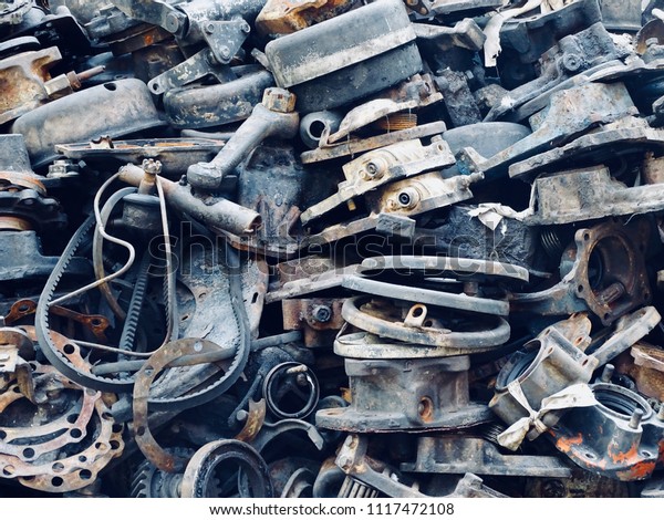 Scrap Car and machinery Parts. Scrap parts in\
garage wall. Scrap parts removed from used cars and machinery.\
Parts isolated from the unused car and machinery. Scraps for second\
used part shop.