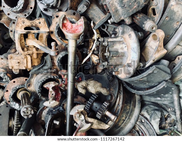 Scrap Car and machinery Parts. Scrap parts wall\
background. Scrap parts removed from used cars and machinery. Parts\
isolated from the unused car and machinery. Scraps for second used\
part shop.