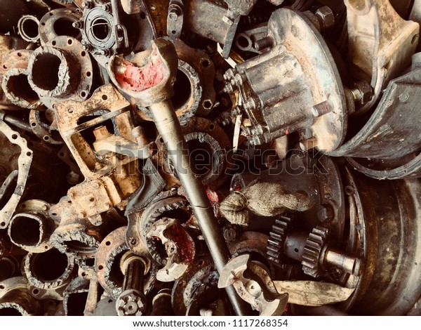 Scrap Car and machinery Parts. Scrap parts wall\
background. Scrap parts removed from used cars and machinery. Parts\
isolated from the unused car and machinery. Scraps for second used\
part shop.
