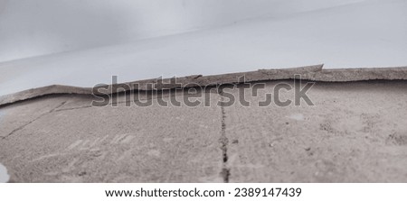 Scrap concrete, rubbish stones, Heap of concrete and brick rubble debris in construction area. Industrial concept. The wall covering is cracked and does not adhere to the bricks, peeling of paint. 