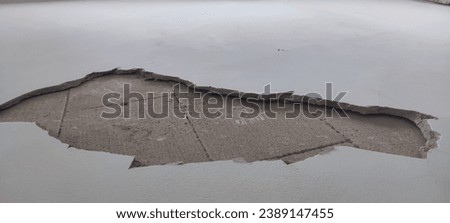 Scrap concrete, rubbish stones, Heap of concrete and brick rubble debris in construction area. Industrial concept. The wall covering is cracked and does not adhere to the bricks, peeling of paint. 