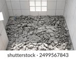 Scrap concrete in toilet room, construction site. Demolished work of tile and concrete floor. To breaking by jack hammer. Cause of bad skill worker. To remove, destruction and re-construction.