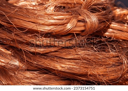Scrap copper stripped cables twisted and collected in a heap, close-up.