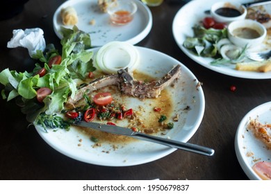 Scrap Of Food In The White Plate After Eating Spicy Steak