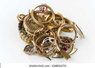 A Scrap Of Gold. Old And Broken Jewellery, Watches Of Gold And Gold-plated On A White Background.