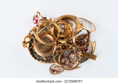 A Scrap Of Gold. Old And Broken Jewelry, Watches Of Gold And Gold-plated On A White Background.