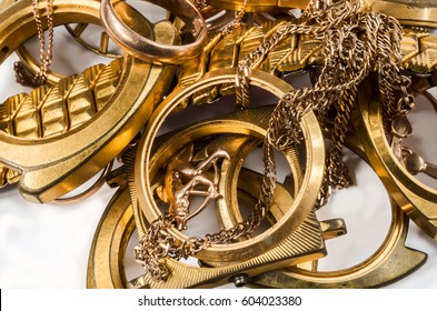 Scrap Of Gold. Old And Broken Jewelry, Watches On A Light Background.