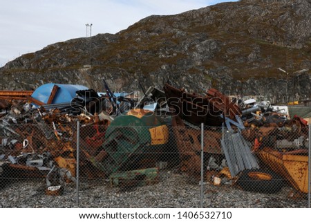 Scrap metal rusts in a garbage dump in a town in southern Greenland