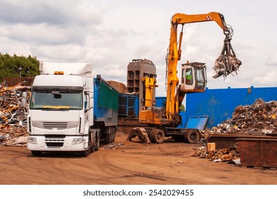 Scrap steel being loaded into a truck after being cut up in shear - Powered by Shutterstock