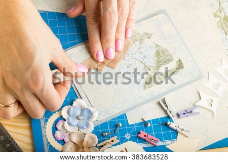 scrapbook background. Hands, Card and tools with decoration