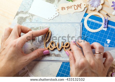 scrapbook background. Hands, Card and tools with decoration. Love
