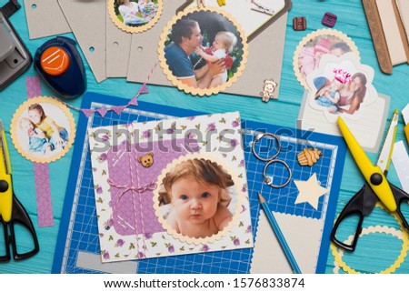 scrapbook background. the process of creating a childrens album. Card and tools with decoration 
