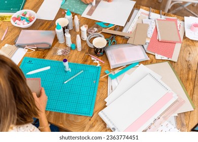Scrapbook workshop. Work table. Tools, cardboard and papers for the workshop