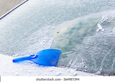 Scraping Ice From The Car Rear Windshield Window