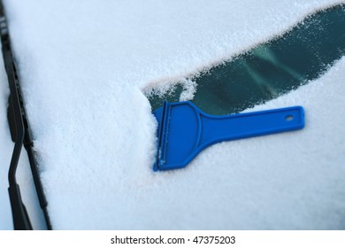 Scraping Snow And Ice From The Car Windshield...