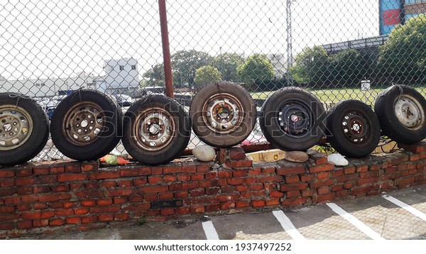 Scrapped tires are used as decoration in\
a car maintenance center in Taoyuan city, Taiwan. Scrapped tires\
are rubber and may cause environmental problems.\
2021-3