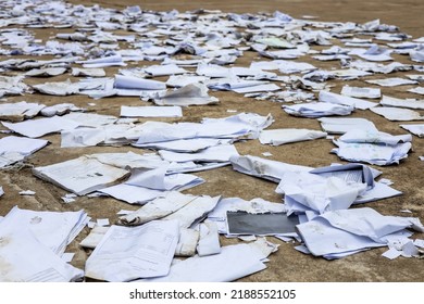 Scraps Of Old Square Paper From Many Notebooks Are Scattered On The Concrete Floor To Dry In The Sun And Then Reused And Sold To Antique Shops In Rural Thailand.