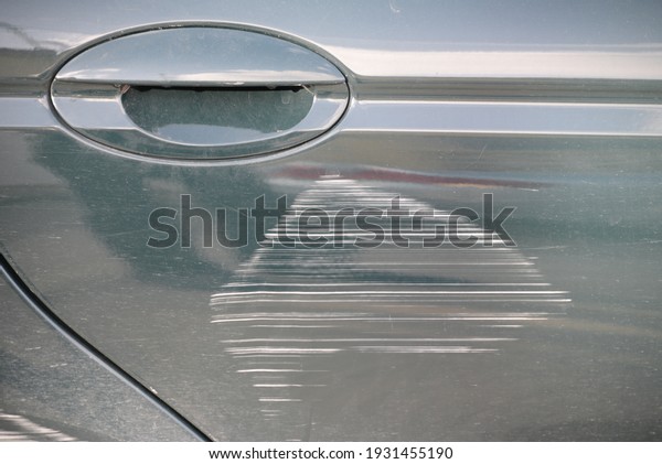 a scratch in a body of a green car, Alicante\
province, Spain, January 2021