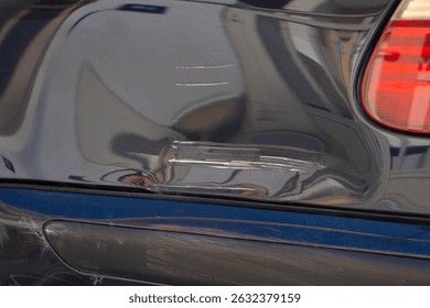 Scratch and dent on car panel, vehicle damage, often resulting from minor collisions or accidents. Damaged car paint need for timely repairs