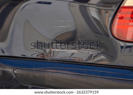 Scratch and dent on car panel, vehicle damage, often resulting from minor collisions or accidents. Damaged car paint need for timely repairs
