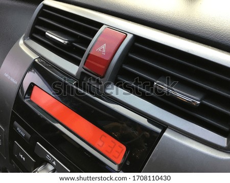 The scratch on the dashboard and air conditioner ducts of black car.